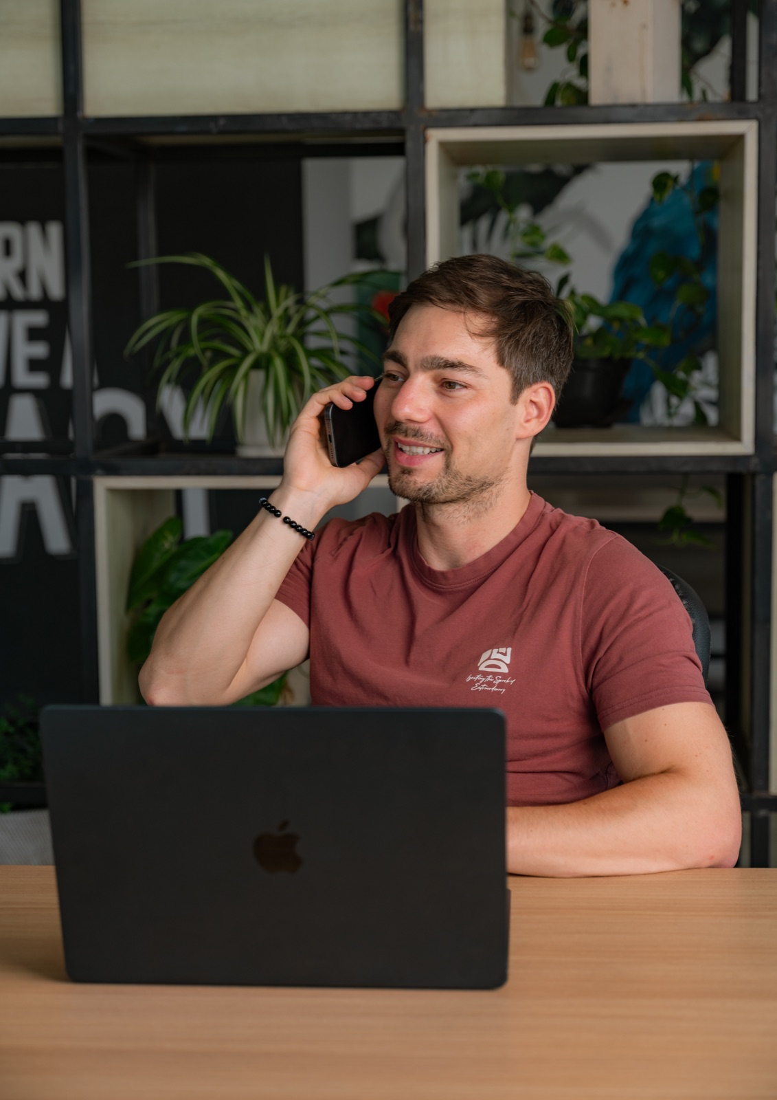 Stef Van Eysendeyk smiling on a phone call at his laptop